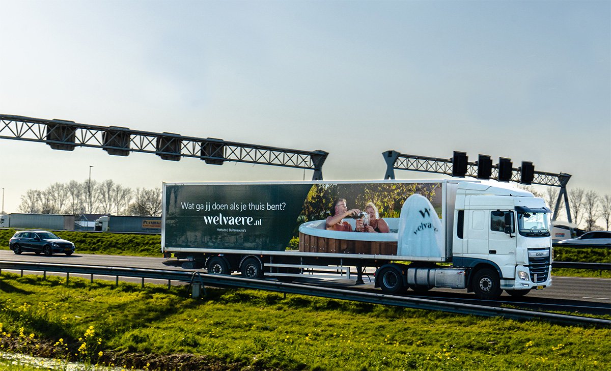 Welvaere Vrachtwagen met reclame op de snelweg